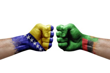 Two hands punch to each others on white background. Country flags painted fists, conflict crisis concept between bosnia and zambia