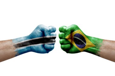Two hands punch to each others on white background. Country flags painted fists, conflict crisis concept between botswana and brazil
