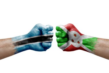 Two hands punch to each others on white background. Country flags painted fists, conflict crisis concept between botswana and burundi