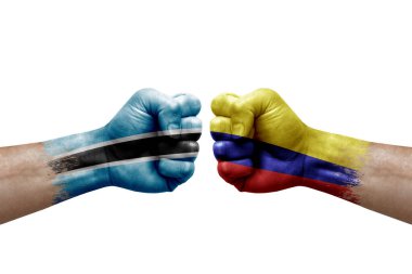 Two hands punch to each others on white background. Country flags painted fists, conflict crisis concept between botswana and colombia