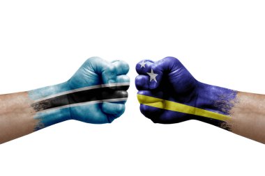 Two hands punch to each others on white background. Country flags painted fists, conflict crisis concept between botswana and curacao