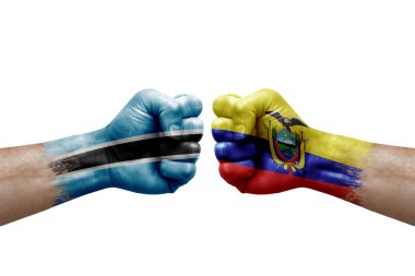 Two hands punch to each others on white background. Country flags painted fists, conflict crisis concept between botswana and ecuador