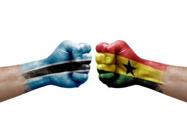 Two hands punch to each others on white background. Country flags painted fists, conflict crisis concept between botswana and ghana