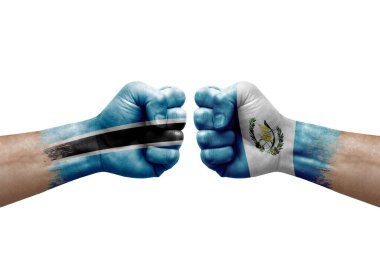 Two hands punch to each others on white background. Country flags painted fists, conflict crisis concept between botswana and guatemala