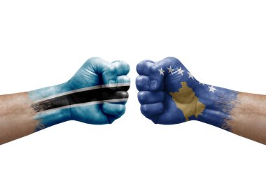 Two hands punch to each others on white background. Country flags painted fists, conflict crisis concept between botswana and kosovo