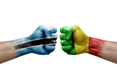 Two hands punch to each others on white background. Country flags painted fists, conflict crisis concept between botswana and mali
