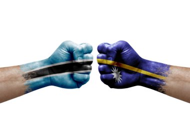 Two hands punch to each others on white background. Country flags painted fists, conflict crisis concept between botswana and nauru