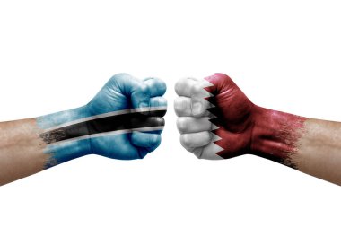 Two hands punch to each others on white background. Country flags painted fists, conflict crisis concept between botswana and qatar