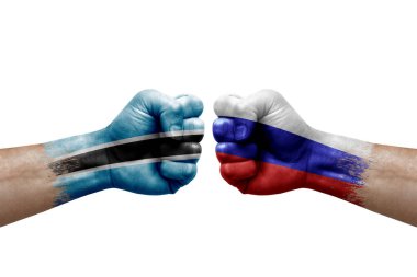 Two hands punch to each others on white background. Country flags painted fists, conflict crisis concept between botswana and russia