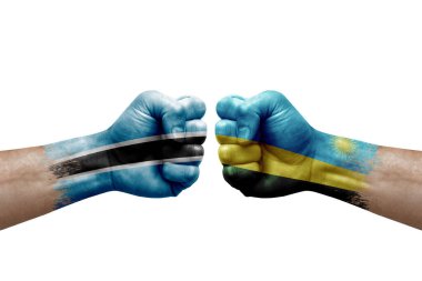 Two hands punch to each others on white background. Country flags painted fists, conflict crisis concept between botswana and rwanda