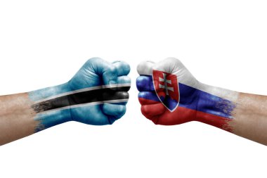 Two hands punch to each others on white background. Country flags painted fists, conflict crisis concept between botswana and slovakia