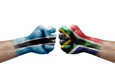 Two hands punch to each others on white background. Country flags painted fists, conflict crisis concept between botswana and south africa