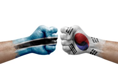 Two hands punch to each others on white background. Country flags painted fists, conflict crisis concept between botswana and south korea