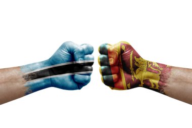 Two hands punch to each others on white background. Country flags painted fists, conflict crisis concept between botswana and sri lanka