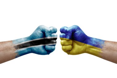 Two hands punch to each others on white background. Country flags painted fists, conflict crisis concept between botswana and ukraine