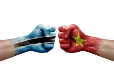 Two hands punch to each others on white background. Country flags painted fists, conflict crisis concept between botswana and vietnam
