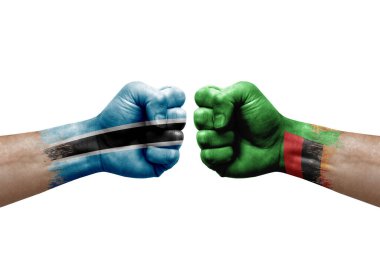 Two hands punch to each others on white background. Country flags painted fists, conflict crisis concept between botswana and zambia