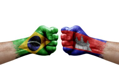 Two hands punch to each others on white background. Country flags painted fists, conflict crisis concept between brazil and cambodia