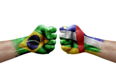 Two hands punch to each others on white background. Country flags painted fists, conflict crisis concept between brazil and central african republic