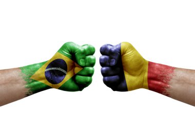 Two hands punch to each others on white background. Country flags painted fists, conflict crisis concept between brazil and chad