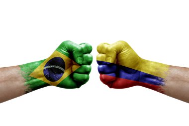 Two hands punch to each others on white background. Country flags painted fists, conflict crisis concept between brazil and colombia
