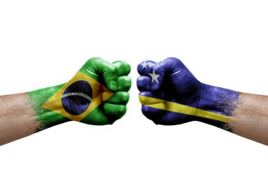Two hands punch to each others on white background. Country flags painted fists, conflict crisis concept between brazil and curacao