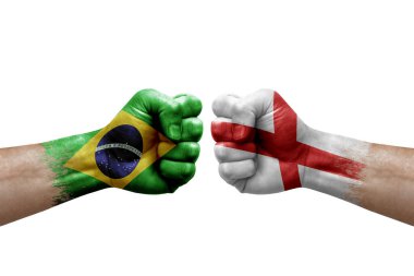 Two hands punch to each others on white background. Country flags painted fists, conflict crisis concept between brazil and england