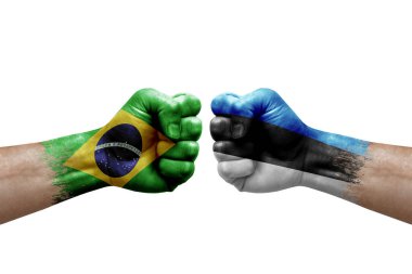 Two hands punch to each others on white background. Country flags painted fists, conflict crisis concept between brazil and estonia