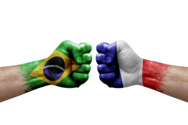 Two hands punch to each others on white background. Country flags painted fists, conflict crisis concept between brazil and france