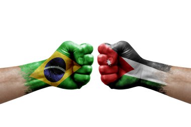 Two hands punch to each others on white background. Country flags painted fists, conflict crisis concept between brazil and jordan