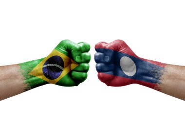 Two hands punch to each others on white background. Country flags painted fists, conflict crisis concept between brazil and laos