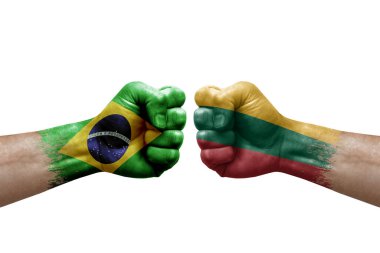 Two hands punch to each others on white background. Country flags painted fists, conflict crisis concept between brazil and lithuania