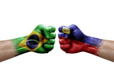 Two hands punch to each others on white background. Country flags painted fists, conflict crisis concept between brazil and liechtenstein