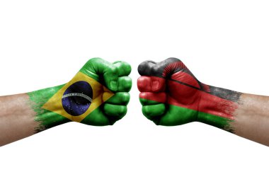 Two hands punch to each others on white background. Country flags painted fists, conflict crisis concept between brazil and malawi