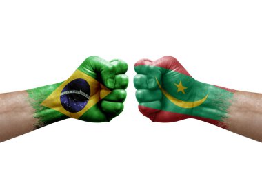 Two hands punch to each others on white background. Country flags painted fists, conflict crisis concept between brazil and mauritania