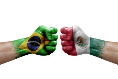 Two hands punch to each others on white background. Country flags painted fists, conflict crisis concept between brazil and mexico