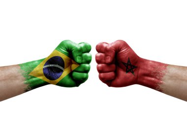 Two hands punch to each others on white background. Country flags painted fists, conflict crisis concept between brazil and morocco