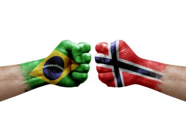 Two hands punch to each others on white background. Country flags painted fists, conflict crisis concept between brazil and norway
