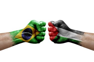 Two hands punch to each others on white background. Country flags painted fists, conflict crisis concept between brazil and palestine