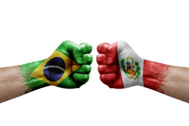Two hands punch to each others on white background. Country flags painted fists, conflict crisis concept between brazil and peru