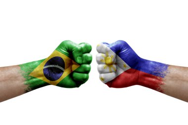 Two hands punch to each others on white background. Country flags painted fists, conflict crisis concept between brazil and philippines