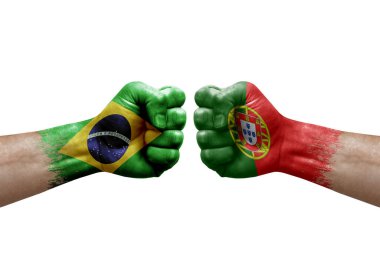 Two hands punch to each others on white background. Country flags painted fists, conflict crisis concept between brazil and portugal