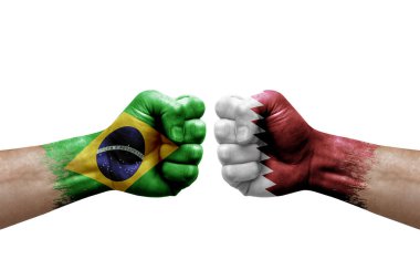 Two hands punch to each others on white background. Country flags painted fists, conflict crisis concept between brazil and qatar