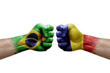 Two hands punch to each others on white background. Country flags painted fists, conflict crisis concept between brazil and romania