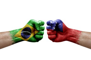 Two hands punch to each others on white background. Country flags painted fists, conflict crisis concept between brazil and samoa