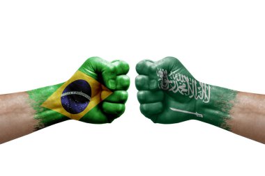 Two hands punch to each others on white background. Country flags painted fists, conflict crisis concept between brazil and saudi arabia