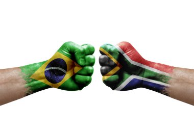 Two hands punch to each others on white background. Country flags painted fists, conflict crisis concept between brazil and south africa