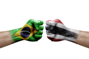 Two hands punch to each others on white background. Country flags painted fists, conflict crisis concept between brazil and thailand