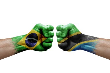 Two hands punch to each others on white background. Country flags painted fists, conflict crisis concept between brazil and tanzania