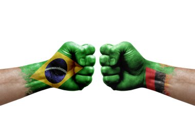 Two hands punch to each others on white background. Country flags painted fists, conflict crisis concept between brazil and zambia